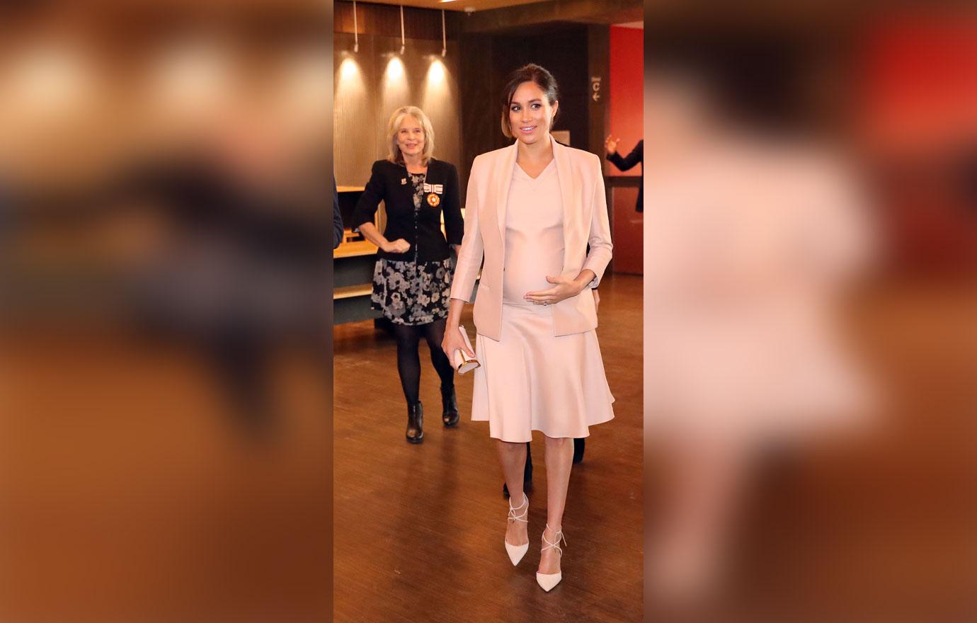 Pregnant Meghan Markle Cradles Stomach During Visit To Royal Theatre