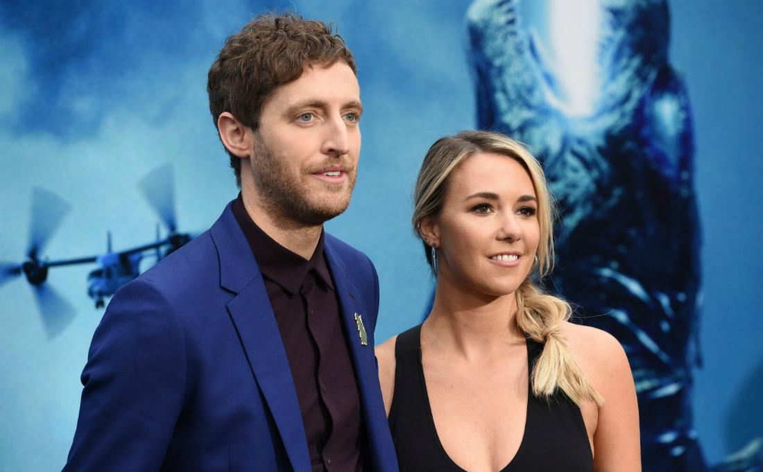 Thomas Middleditch and Mollie Gates stand on the red carpet. He's ina blue jacket and black top; she's in a black dress.