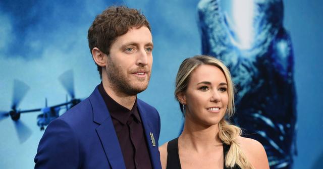 Thomas Middleditch and Mollie Gates stand on the red carpet. He's ina blue jacket and black top; she's in a black dress.