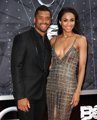 Russel Wilson and Ciara post for a photo.