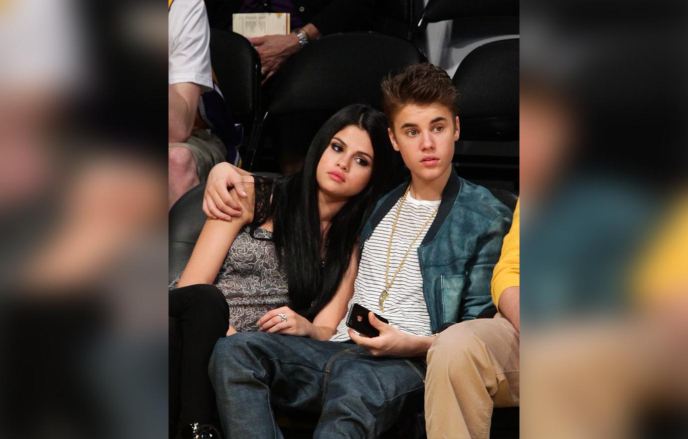 Justin Bieber Sits With His Arm Around Selena Gomez Sitting Watching Game