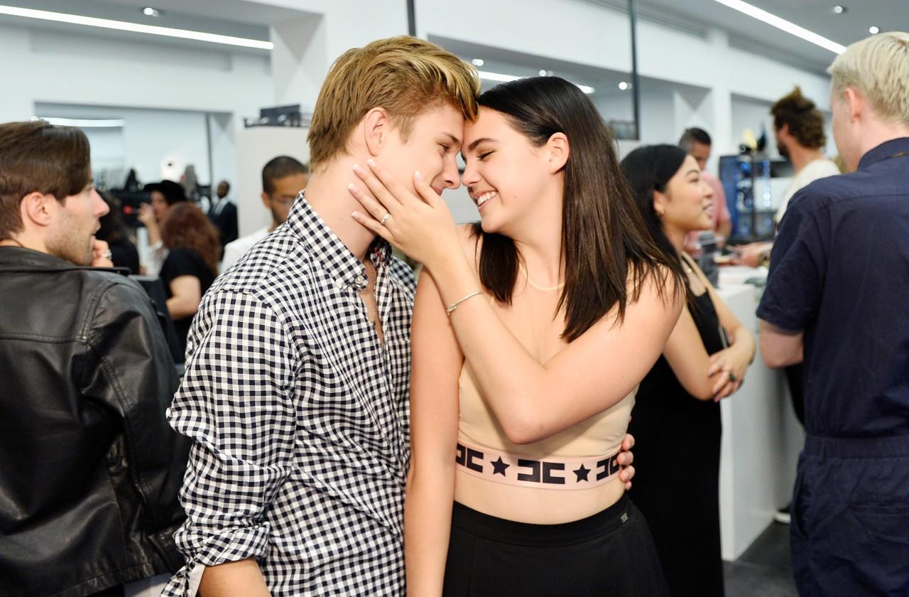 Bailee Madison caresses Alex Lange's face on the red carpet