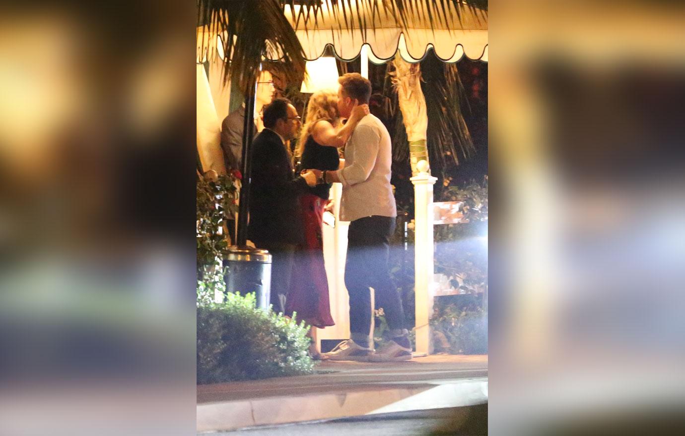 Jennifer Aniston kisses a male friend goodbye after having dinner in Los Angeles. The 50 year old actress is wearing a red skirt with a black top. She dined at the restaurant with a few friends including a mystery man who she gave a hug and a kiss to on the cheek before departing.