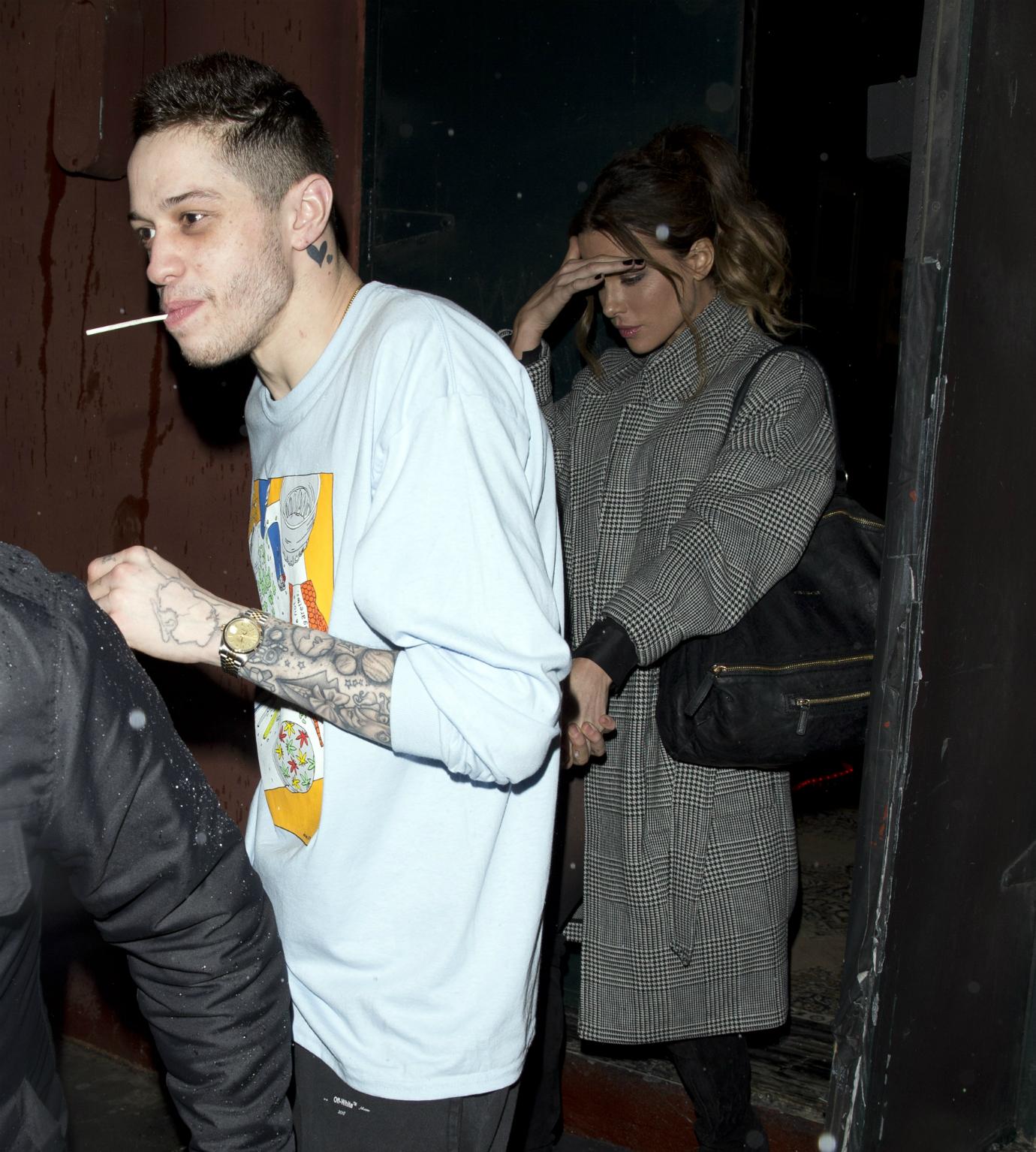 Pete Davidson and Kate Beckinsale walk hand in hand.