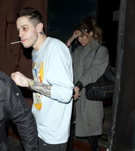 Pete Davidson and Kate Beckinsale walk hand in hand.