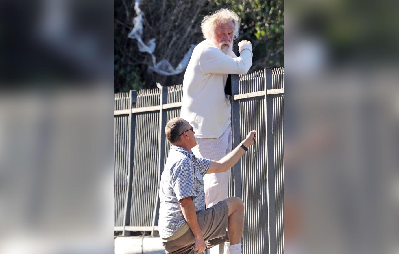 //Nick Nolte Climbs Fence Photos