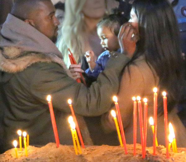 Kim & Khloe Kardashian Light A Candle In Armenia With North West