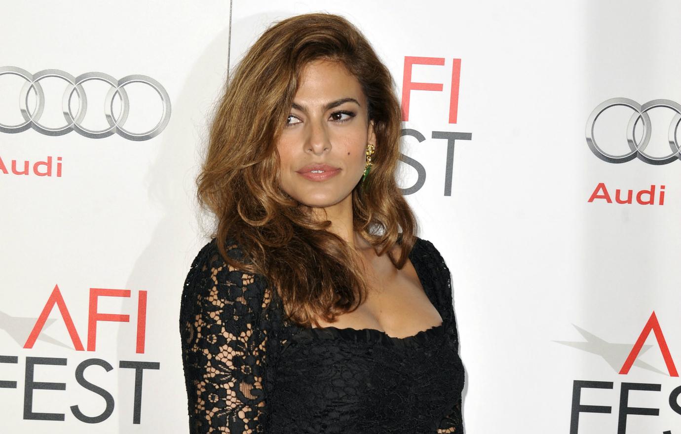 Eva Mendes wears a black lace dress, minimal makeup and hair worn down and wavy at the 2012 AFI fest.
