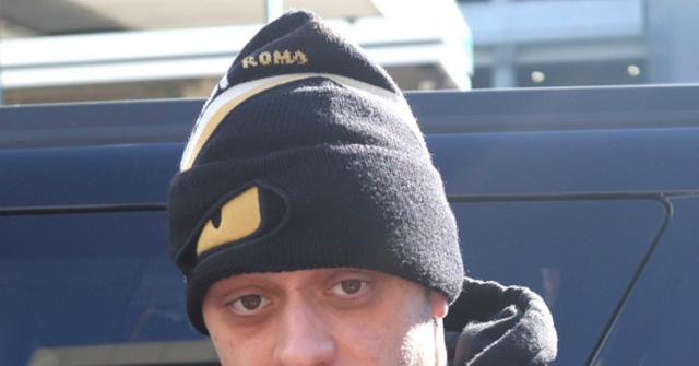 Pete Davidson looks into the camera while wearing a hat.