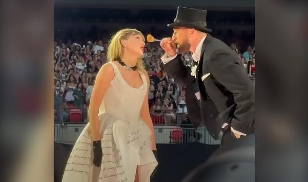 travis kelce on stage with taylor swift londn eras concert