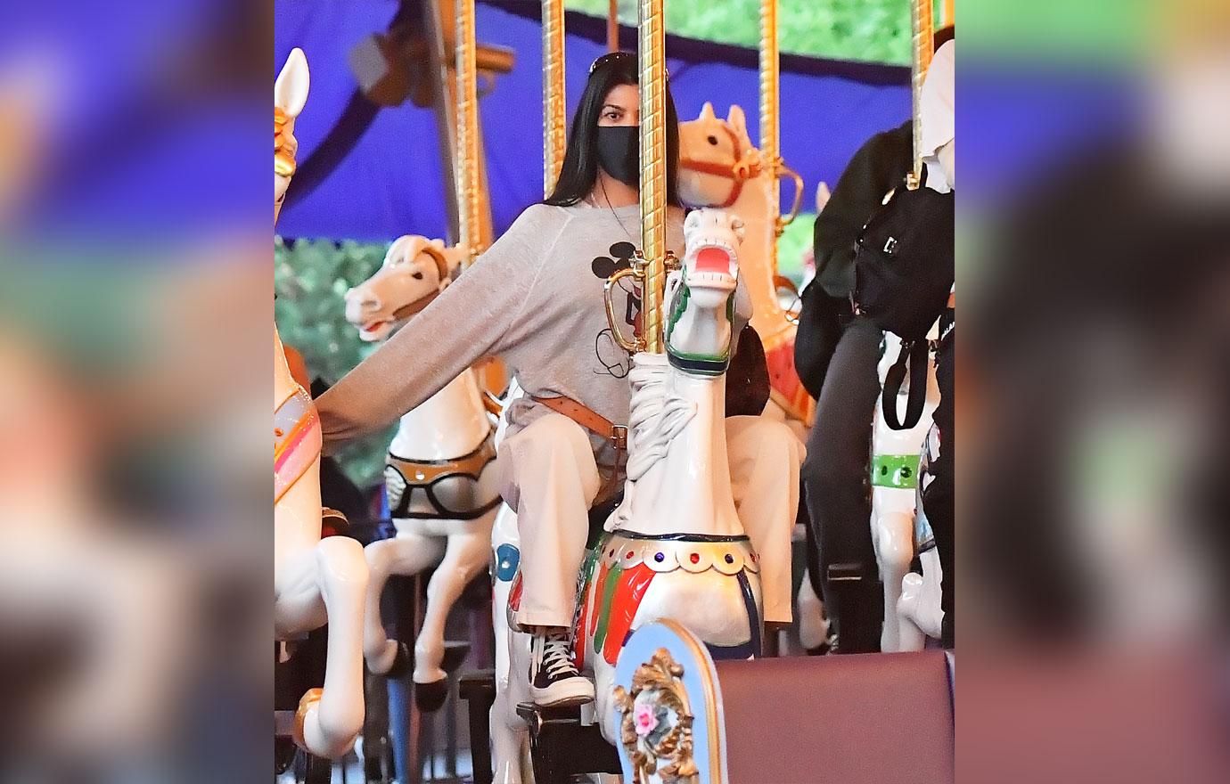 kourtney kardashian and travis barker take their modern family on a fun day out at disneyland