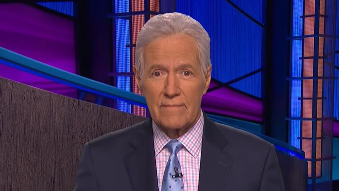 Alex Trebek Smiles in a Suit on Jeopardy Set