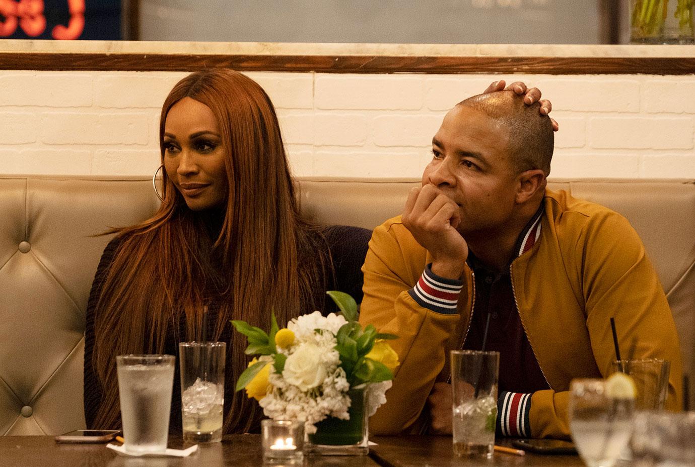 Cynthia Bailey And Mike Hill Sitting At Table While Cynthia Caresses Mike's Head