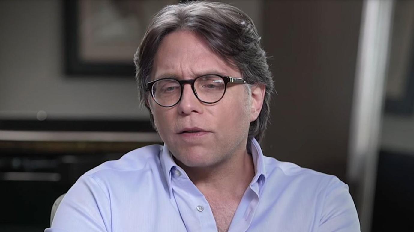 Keith Raniere Closeup Looking Serious in Light Purple Shirt and Glasses