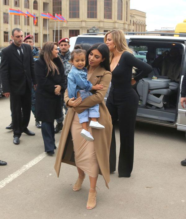 Kim & Khloe Kardashian Light A Candle In Armenia With North West