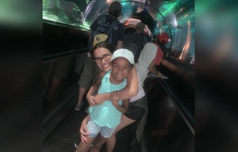 Briana Dejesus poses for a photo with her children at the aquarium.