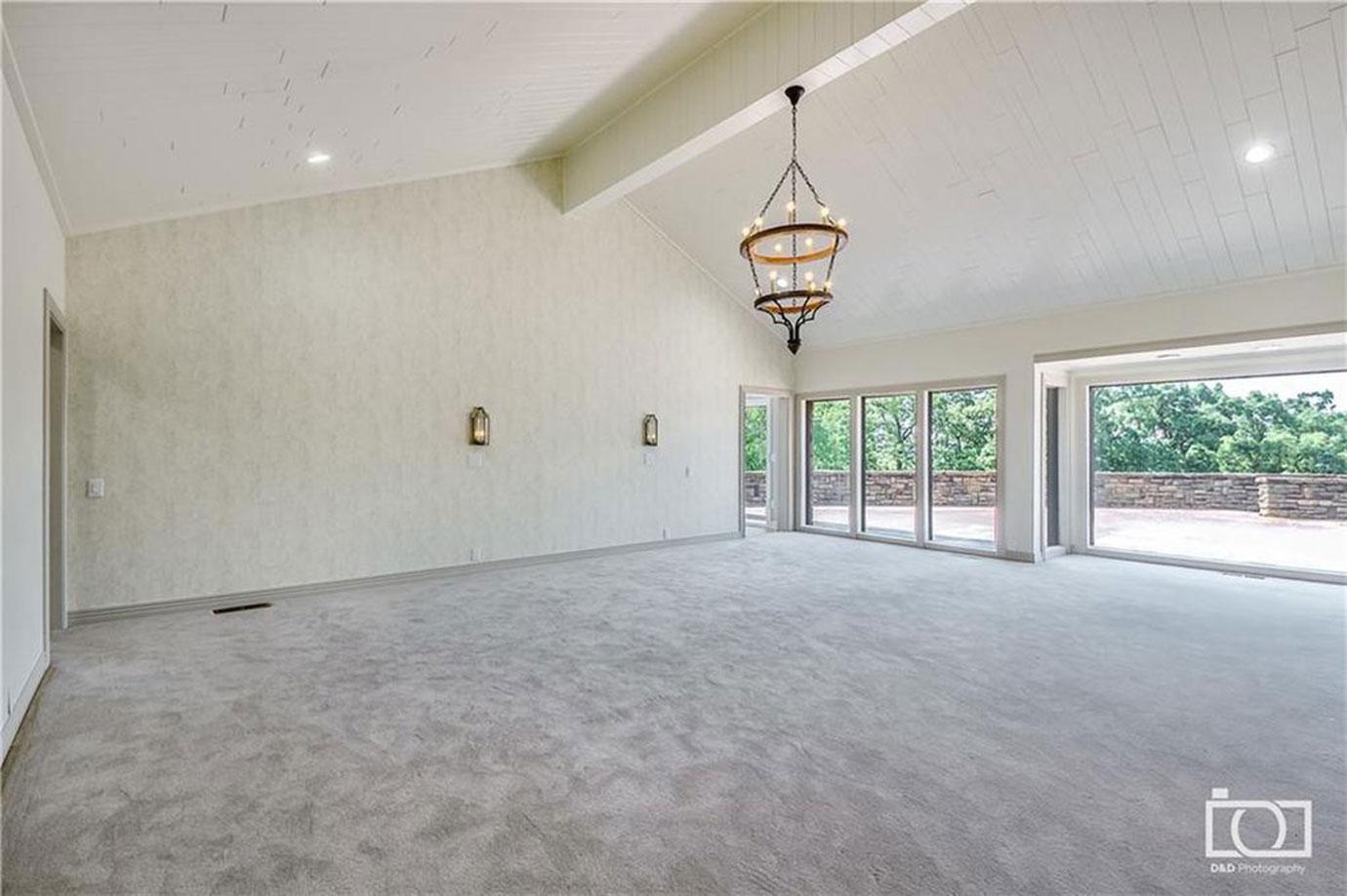 Master Bedroom With Carpeting And Acess To Back Patio