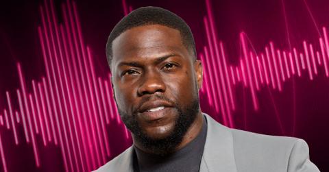 Closeup Of Kevin Hart Wearing Medium Gray Turtleneck and Light Gray Blazer WIth Pink Audio Waves in Background