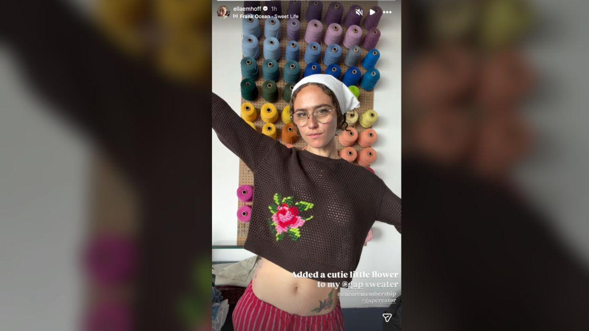 image of The model's open-knit crop top featured a pink flower she stitched onto the garment herself.