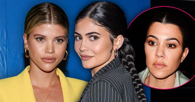 Sofia Richie Wearing Yello Suit And Kylie Jenner Wearing Black And Grey Pinstripe Suit With an Inset Of Kourtney Kardashian Looking At Them