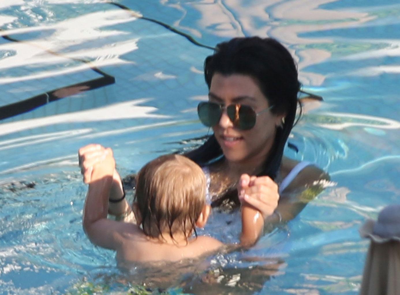 //kourtney kardashian swimsuit pool kids baby reign