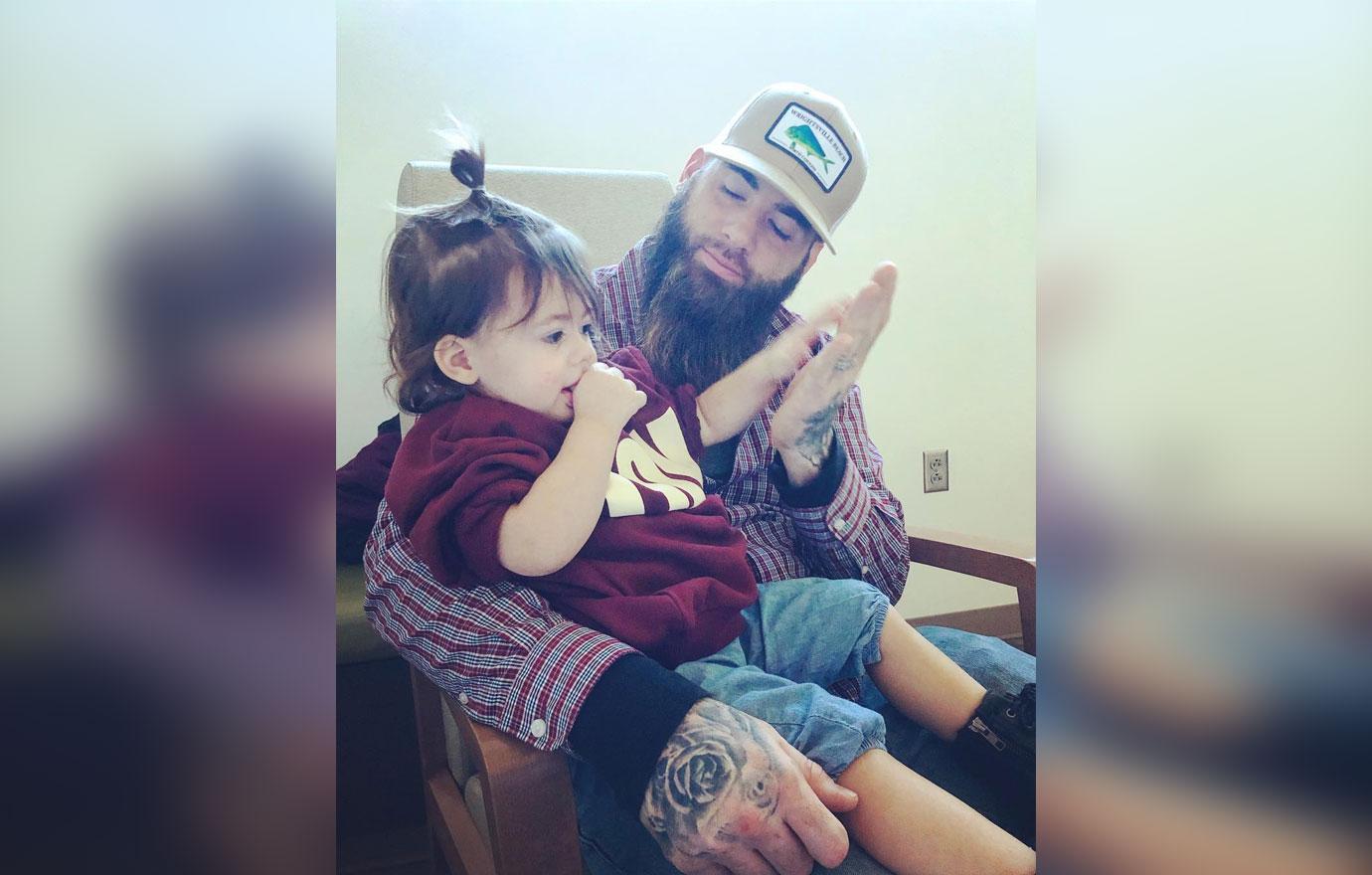 David Eason holds one of his children.