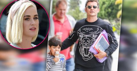 Inset Of Blonde Katy Perry looking at Photo Of Orlando Boom Wearing Sunglasses, Sweatshirt Walking With His Son Flynn Wearing Stripped Shirt