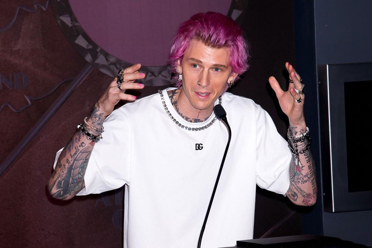 Machine Gun Kelly said celebrity inker Roxx warned him the tattoo transformation would be 'near impossible' before the process left him seriously ill.