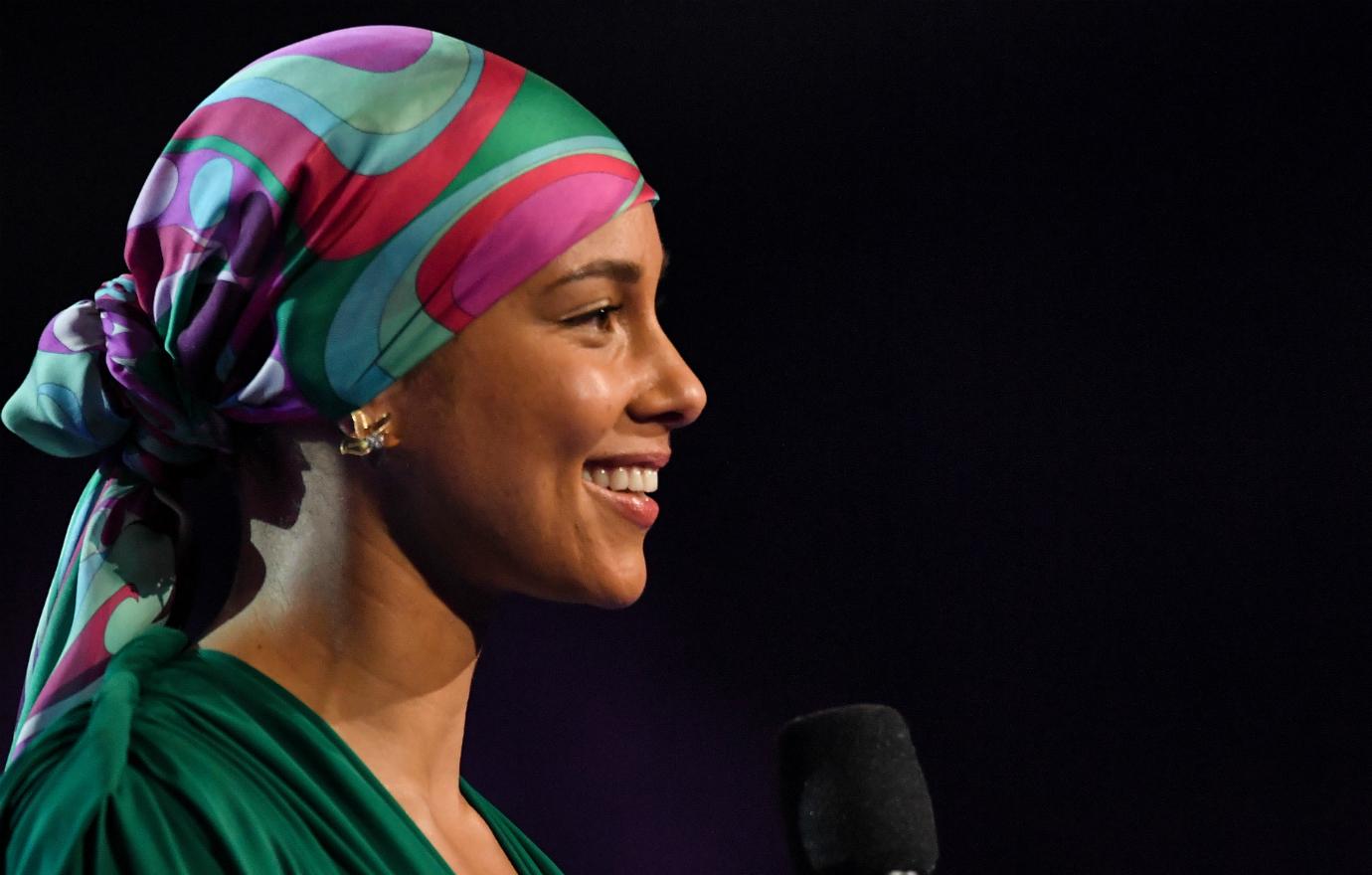 Alicia Keys hosted the Grammy Awards and looked sensational in a green dress and a multi-colored scarf.