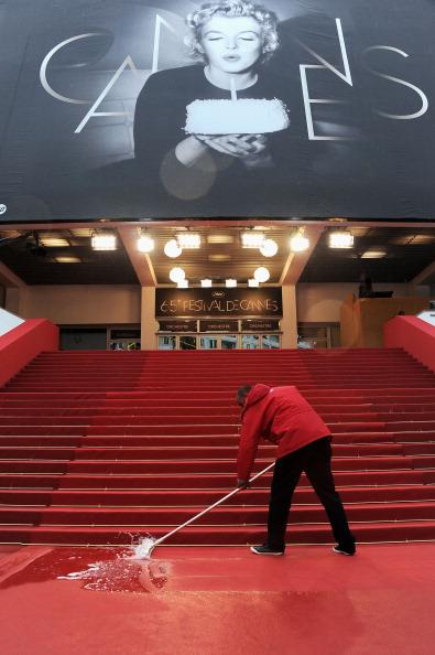 // staff sweep water from the red carpet gettyimages