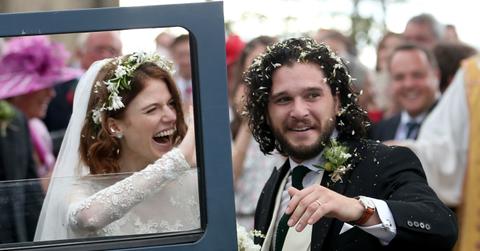 Kit Harington and Rose Leslie smile on their wedding day with their Land Rover Defender getaway car