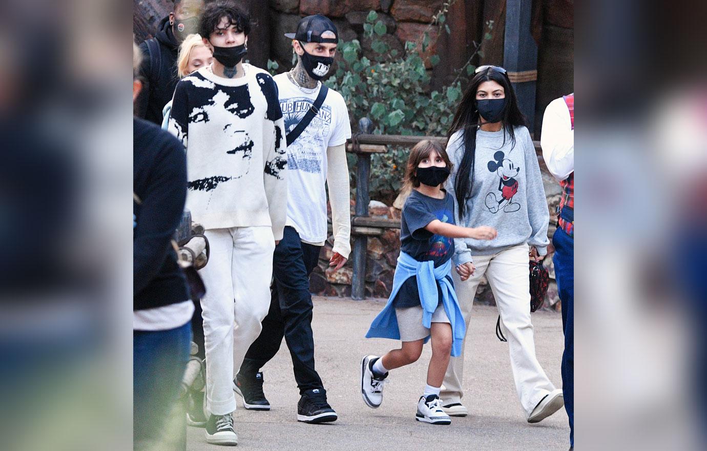 kourtney kardashian and travis barker take their modern family on a fun day out at disneyland