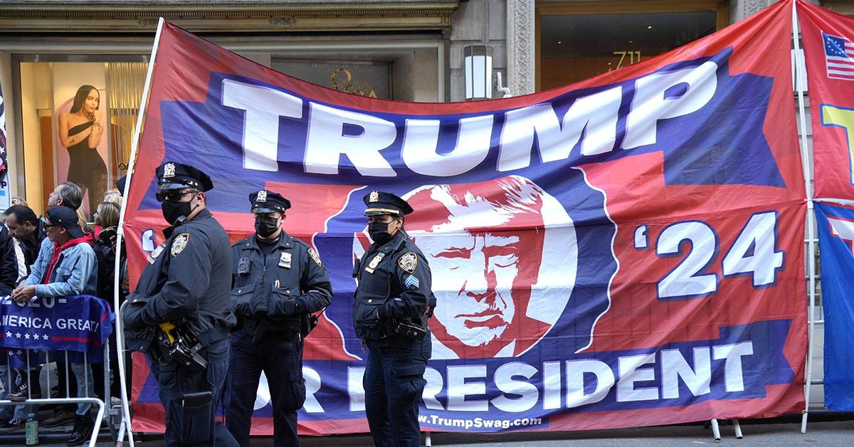 maga supporter trump arraignment protest rips flag