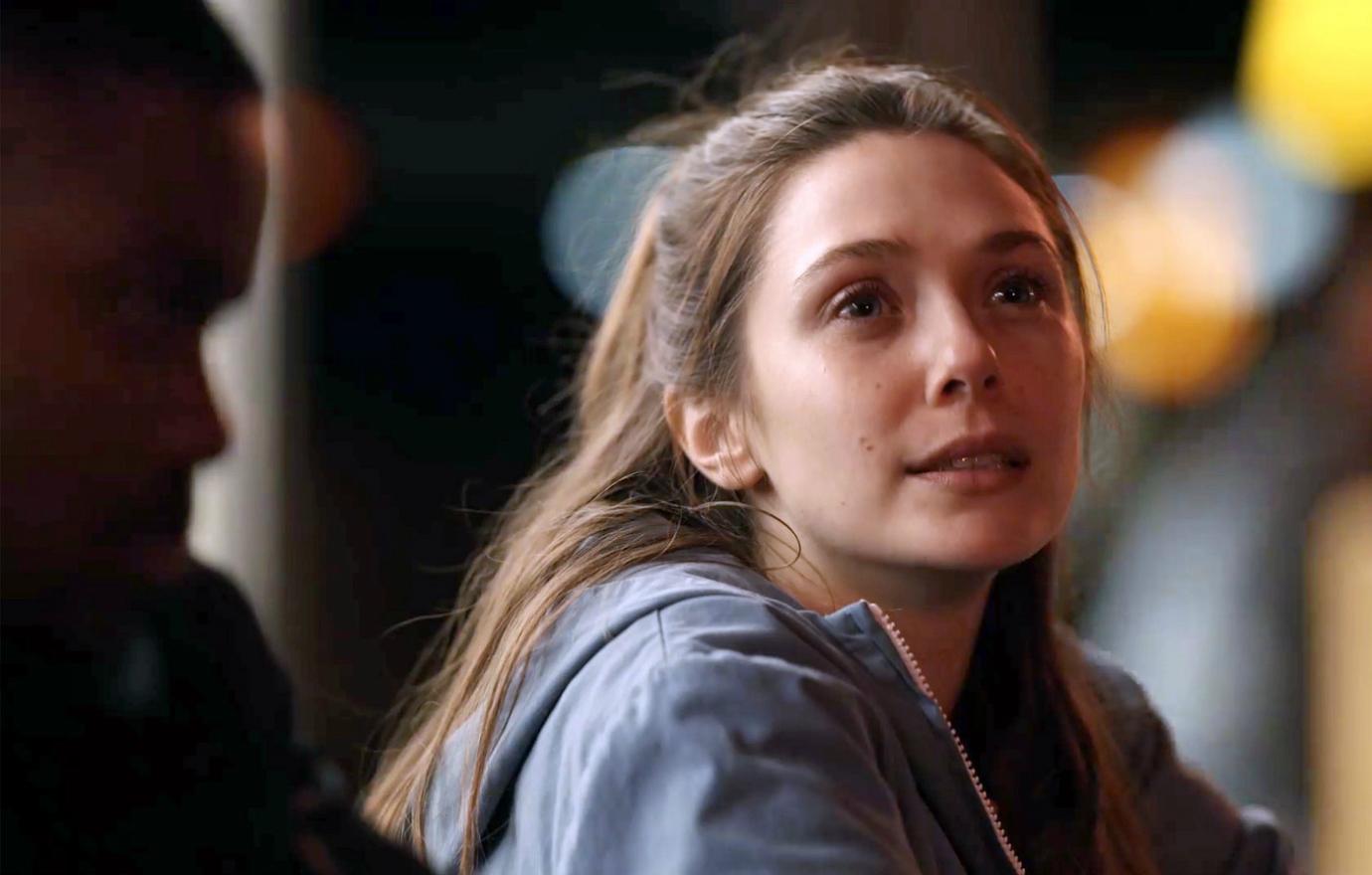 Elizabeth Olsen looked off into space in a grey hoodie in a scene from Sorry for Your Loss.