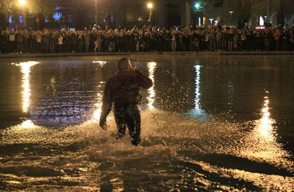 Kanye West jumps into water as fans, cops, jump in along with the soaking wet rapper at last minute concert in Armenia. Kanye decided to organize the show at literally 9pm on late Sunday night and by using social media over 3,000 screaming fans showed up at the duck pond to watch him perform at nearly 1:20am local time. Kanye was on stage singing his hit when his mic started to short out as the crowd noticed. Minutes later he asked a section of the crowd if they could see him and after realizing they could not, he jumped literally into the middle of the duck pond and drops his mic into the water due to it being too wet and ruined. He is then literally surrounded by the fans as they run into the water with him as his bodyguard Pascal is spotted running to his side along with the Armenian National Guard and Police all getting soaking wet to retrieve the rap star. Kanye was then brought closer as a fan tried to touch his hand, the cops pushed him and Kanye reacted to holding the cops back to let the fan get a photo with him in the pond too! Madness occurs in a stampede style follow as Kanye is finally pulled to the top of the pond and is guided with his entourage out of the park with thousands running and following him out of the concert. Kim Kardashian was shown on side stage watching her man perform and was all smiles