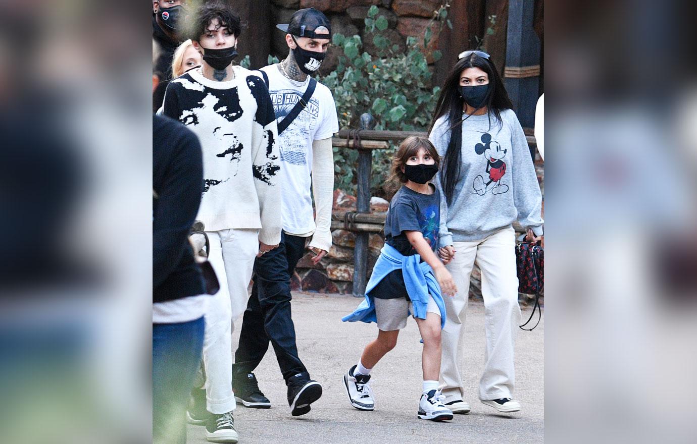 kourtney kardashian and travis barker take their modern family on a fun day out at disneyland