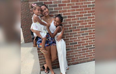 Briana Dejesus poses for a photo with two of her children.
