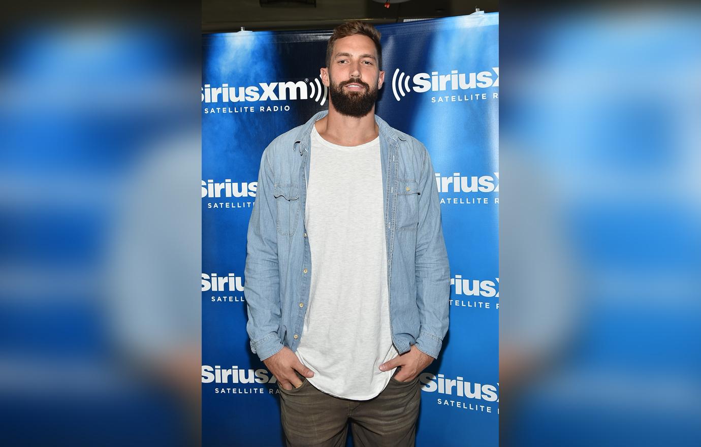 Jordan Cameron is wearing a denim button up on top of a white shirt.