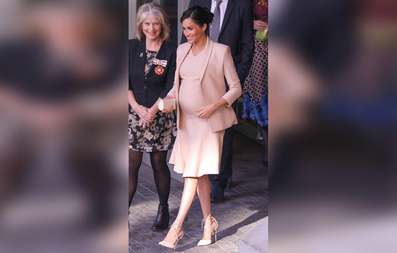 Pregnant Meghan Markle Cradles Stomach During Visit To Royal Theatre