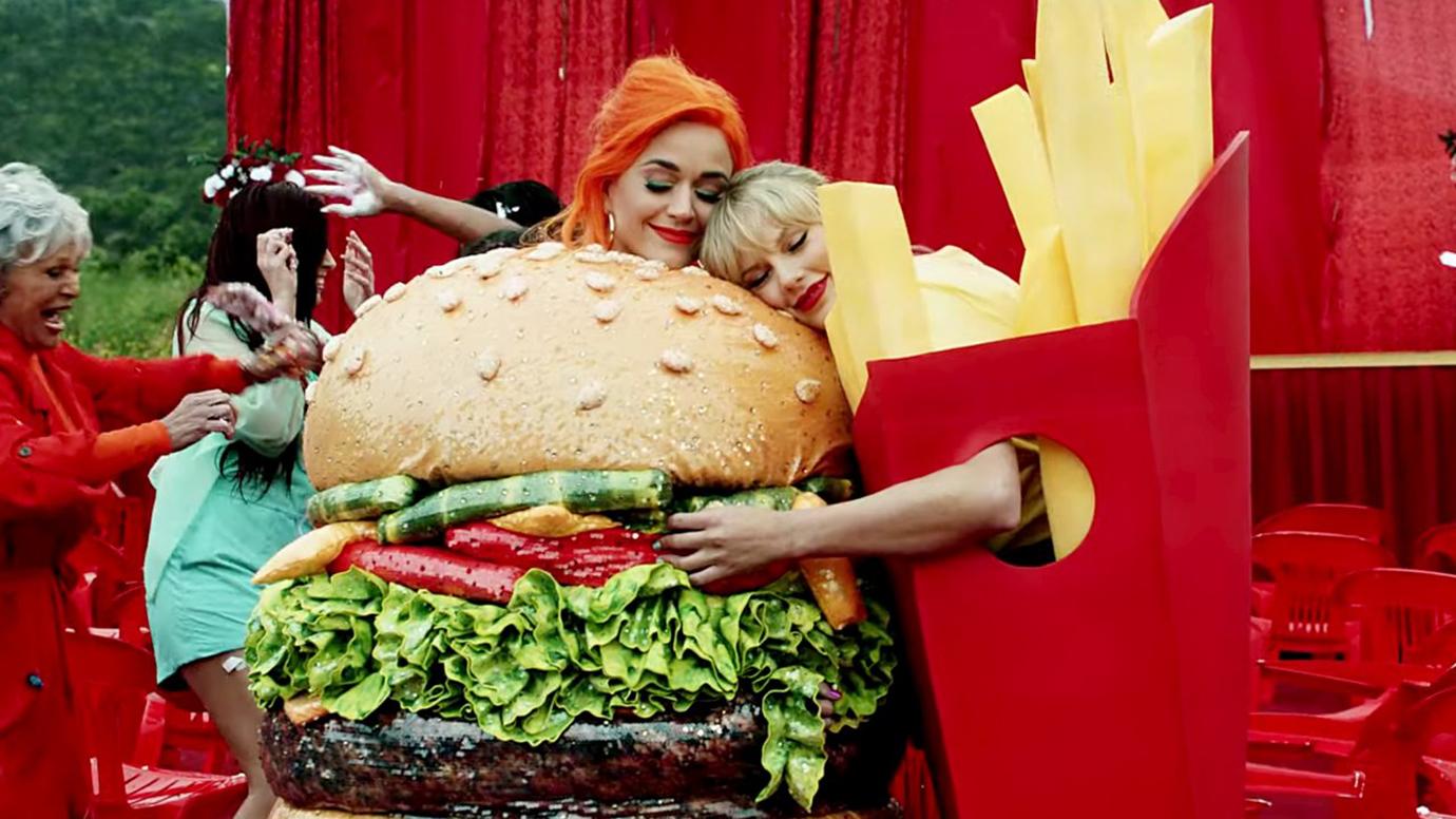 Katy Perry Dressed Like a Hamburger Being Hugged BY Taylor Swift Dressed Like Fries