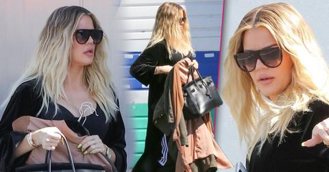 Khloe Kardashian covers baby bump