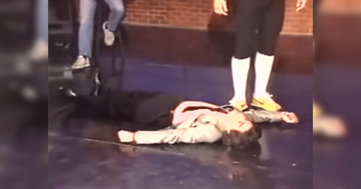 Photo of Richard Belzer laid out on stage. 