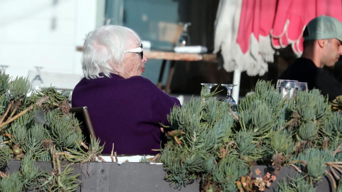 image of The Oscar winner was helped toward a waiting car after dining outdoors at an oceanside eatery.