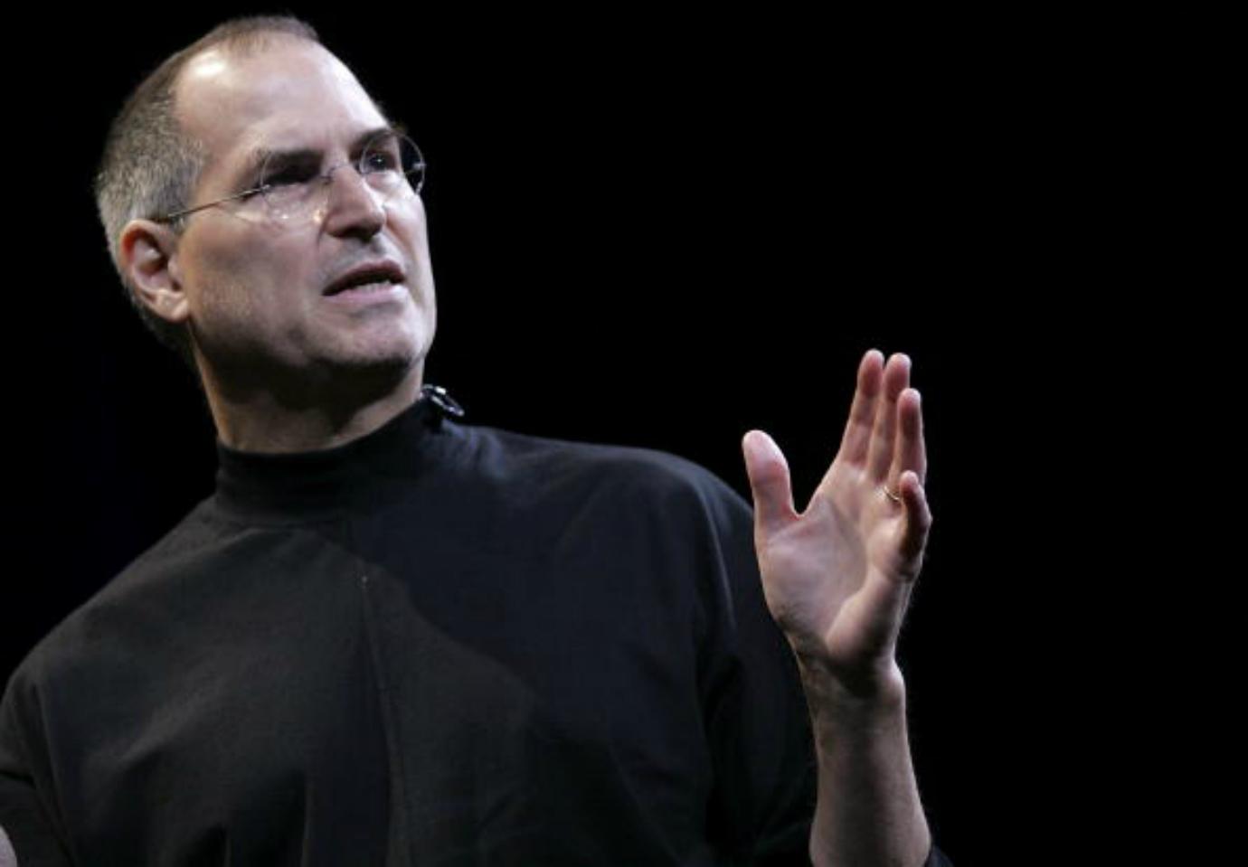 Steve Jobs speaks on stage.