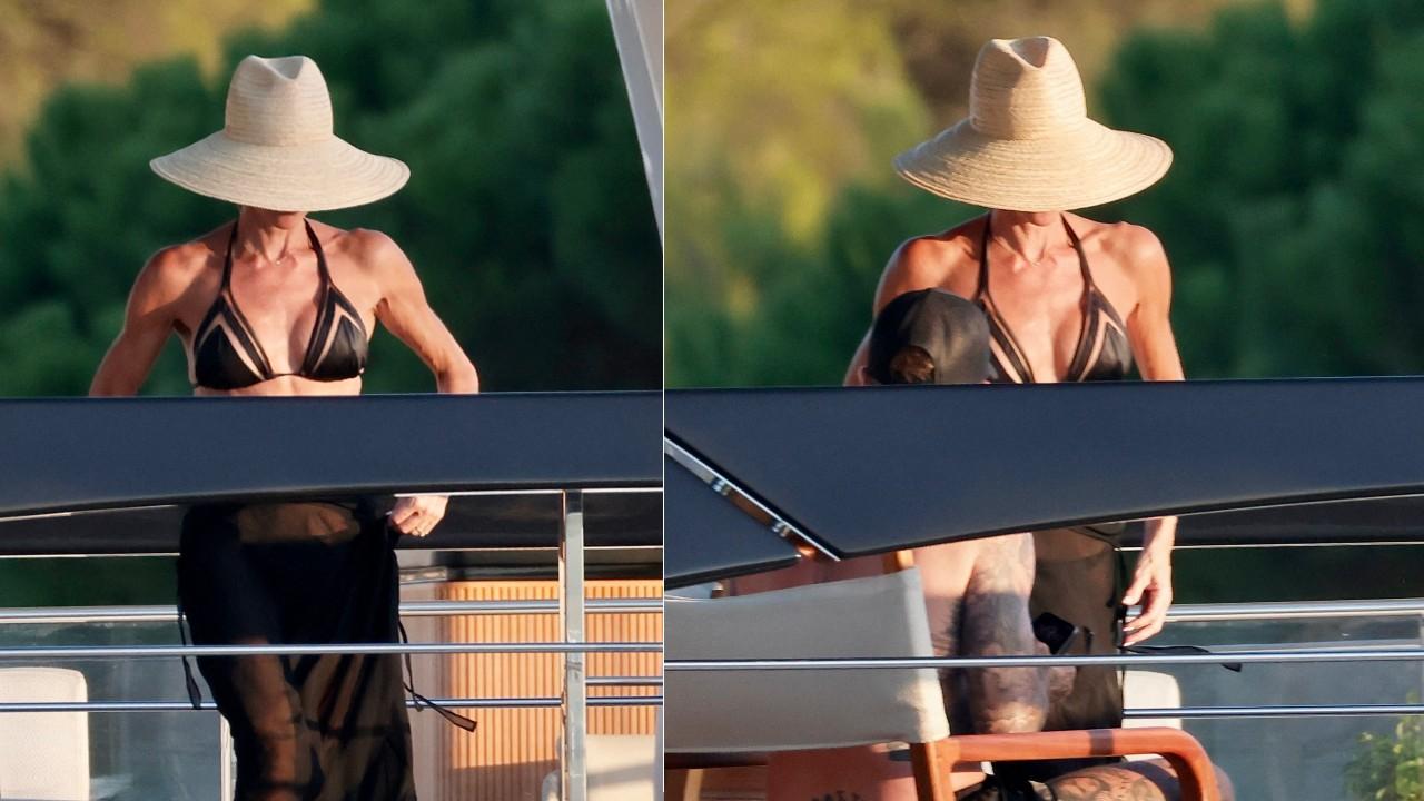 Victoria Beckham wore a black swimsuit and matching sarong.