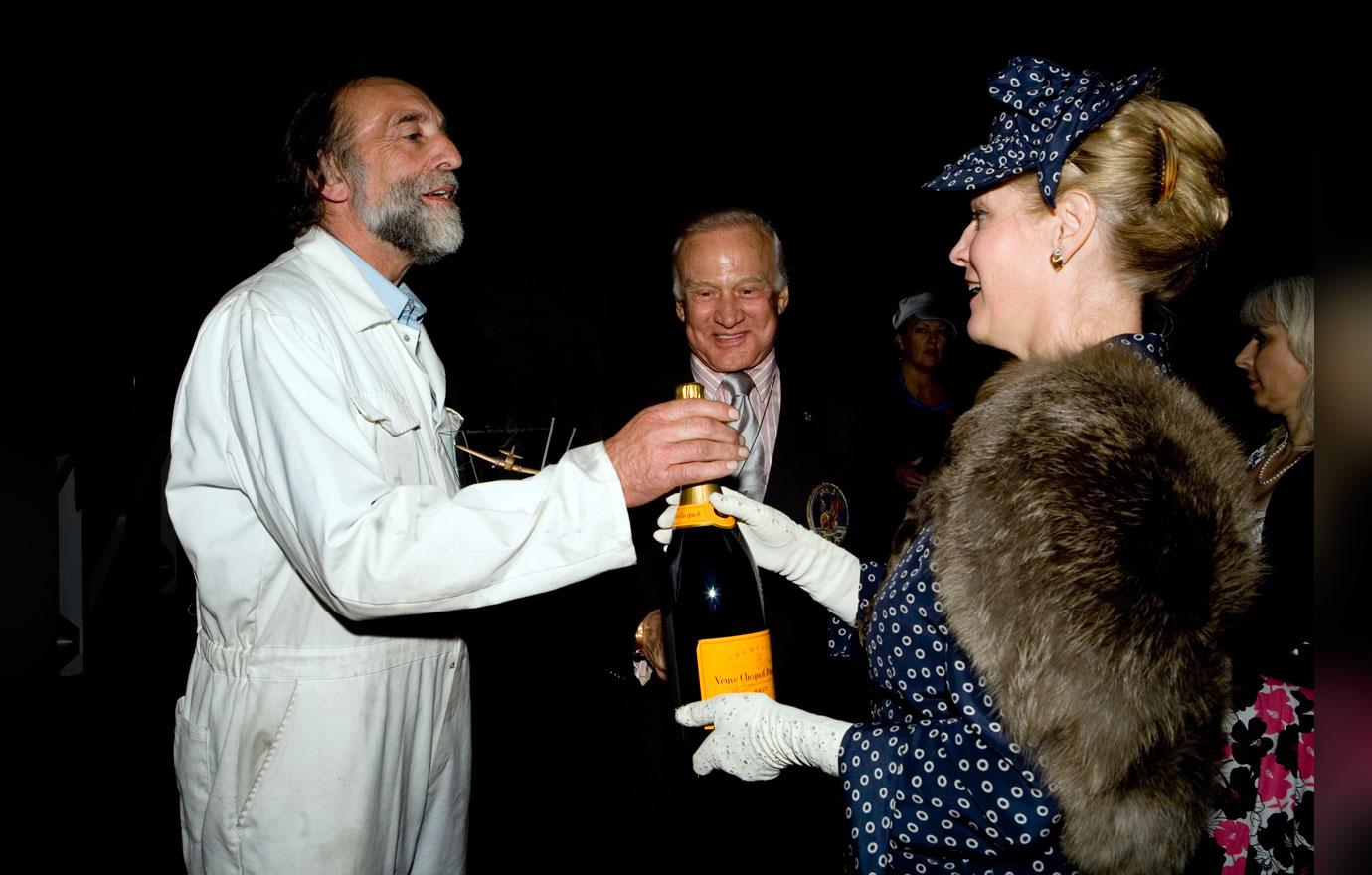 Spirit of Aviation winner Mark Rijkse being presented with magnum of champagne by Lady March - Buzz Aldrin in background.