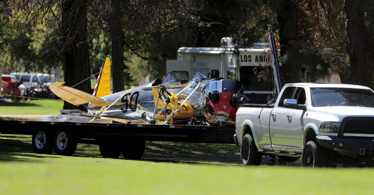 Wreckage of Ford's plane being carried off Penmar Golf Course in Venice, California.