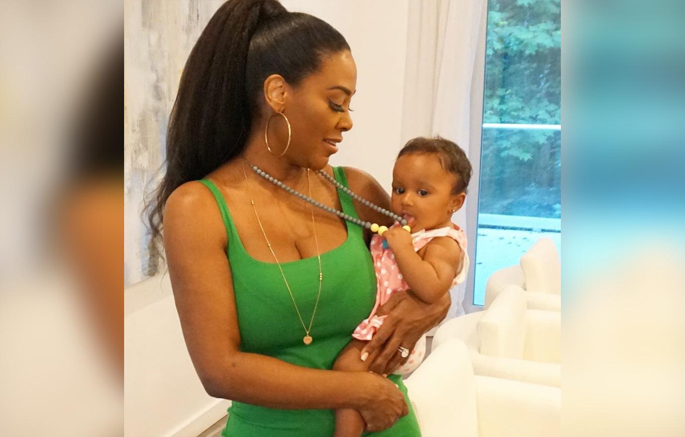 Kenya Moore holds on to her baby.