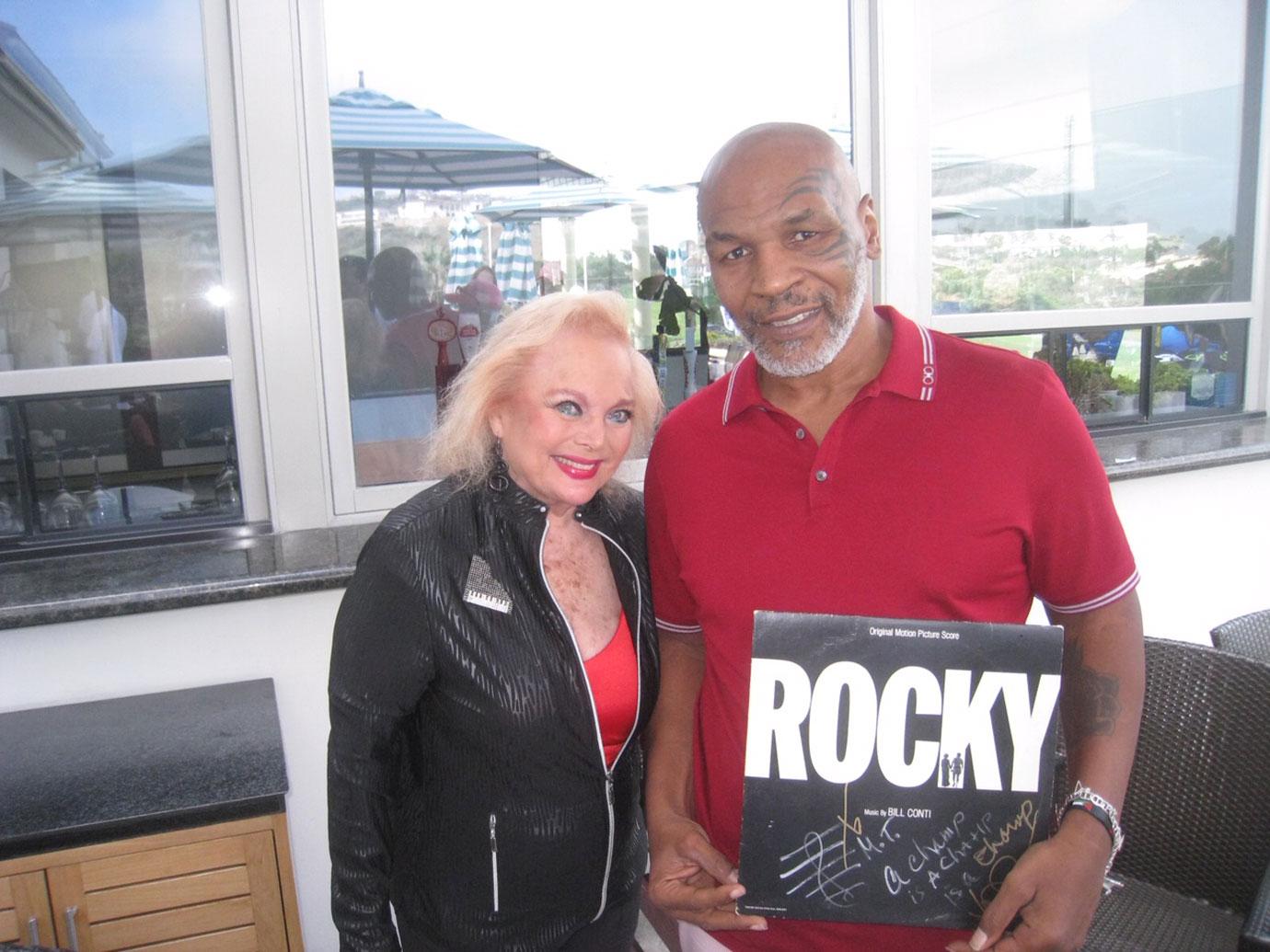 Oscar nominated singer-songwriter Carol Connors presents Mike Tyson with a signed original copy of her famed album "Gonna Fly Now" from the hit film "Rocky"