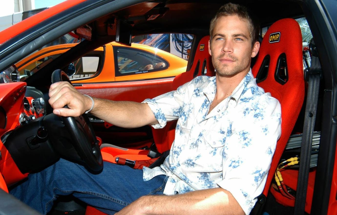 Paul Walker sitting in a car